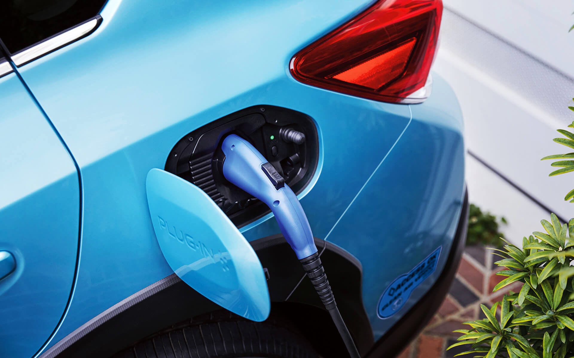 A close-up of the Subaru Crosstrek Hybrid's charging port with charging cable plugged in | Dyer Subaru in Vero Beach FL